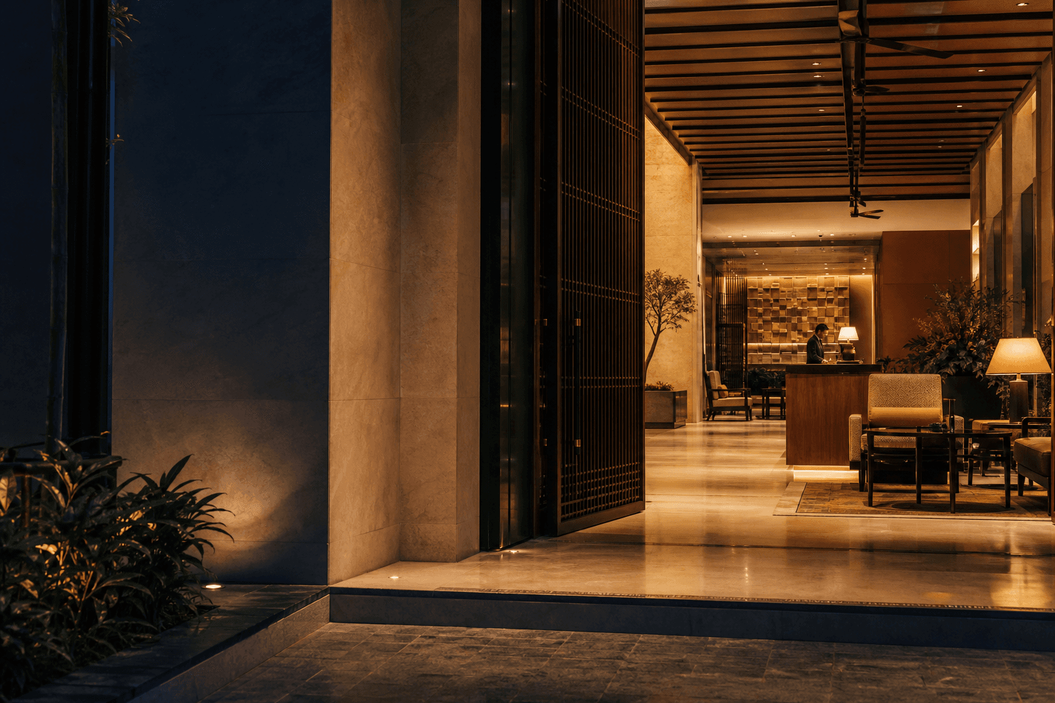 A warmly lit contemporary hotel entrance at night